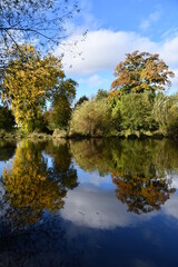 Fototapeta na wymiar Autumn colours reflection on a river Nore, Kilkenny, Ireland
