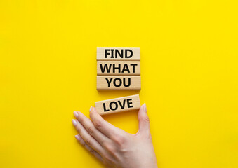 Find what you love symbol. Concept words Find what you love on wooden blocks. Beautiful yellow background. Businessman hand. Business and Find what you love concept. Copy space.