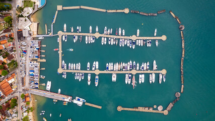 aerial image of speedboats and sailboats moored in a sea park