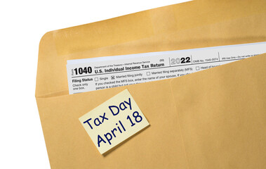 Printed copy of Form 1040 for income tax return for 2022 with reminder for April 18 2023 deadline