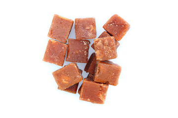 brown sugarcane cubes on white background.