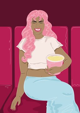 Girl sitting in cinema with popcorn