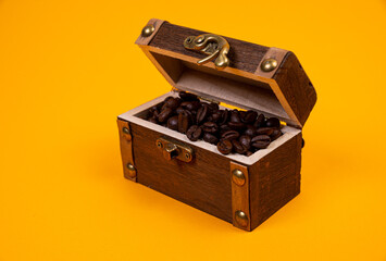 chest with coffee , Image of middle-aged coffee beans. Poured into a pirate chest. Precious, expensive, tonic, invigorating, fragrant, delicious, high-quality, roasted drink. Brown,