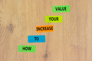 Increase your value symbol. Concept words How to increase your value on colored paper. Beautiful wooden table wooden background. Business how to increase your value concept. Copy space.