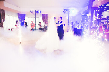 Beautiful caucasian wedding couple just married and dancing their first dance