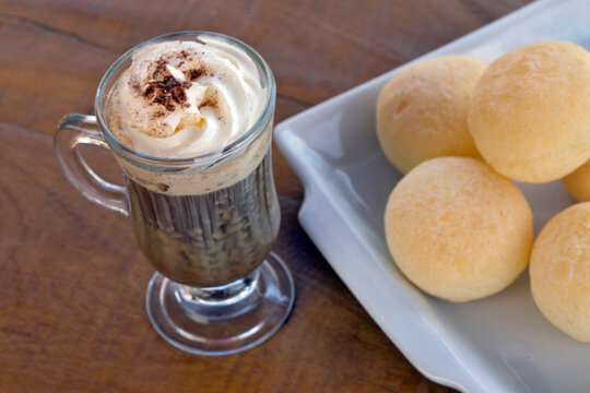 Portion of cheese bread, traditional Brazilian snack with cappuccino