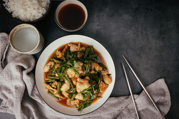 Top view Stir-fried pork and red hot curry paste with long bean and  Ingredients are oyster sauce, fish sauce, sugar, kaffir lime leaves in the dish Eat with cooked rice. Thai cuisine
