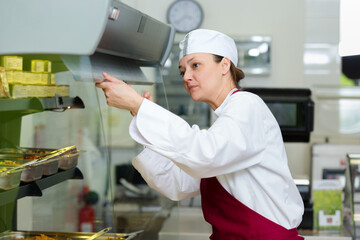 buffet female worker in servicing food