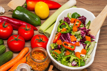 Healthy and fresh salad in bowl with vegetables and fruit