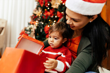 Mother and her baby playing at home on Christmas holiday