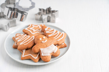 Homemade spiced organic gingerbread biscuits or crunchy cookies with white sugar icing served on...