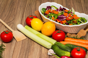 Healthy and fresh salad in bowl with vegetables and fruit