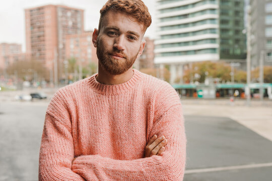 Young redhead man looking on camera outdoor