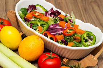 Healthy and fresh salad in bowl with vegetables and fruit