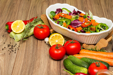 Healthy and fresh salad in bowl with vegetables and fruit