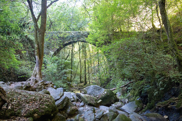 Obraz premium Medieval bridge of the Sesín river, next to the monastery of Caaveiro, Gragas do Eume, Pontedeume, A Coruña