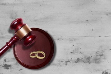 Law concept. Judge wooden gavel and rings on board