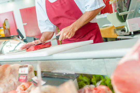 a butcher is working with bio meat
