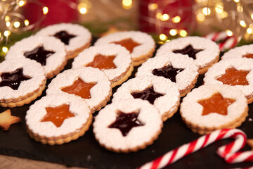 Handmade Christmas cookies against a backdrop of glowing lights. Linzer Cookies. Holiday baking and decor for Christmas and New Year