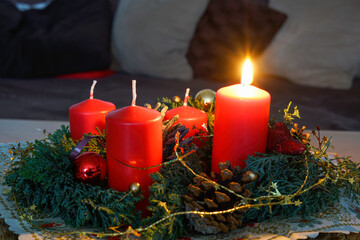 Christmas with red candles and christmas tree balls and fir branches and pine cones