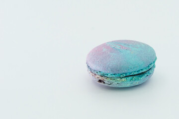 Blue French macaroon isolated on white background. Tasty colourful macarons. Cookie made of two smooth halves, fastened with stringy fillings. French pastry made from egg whites.