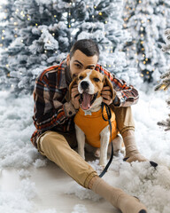 Cute New Year's photo of a man and his dog. Portrait festive photos of a dog in New Year's...