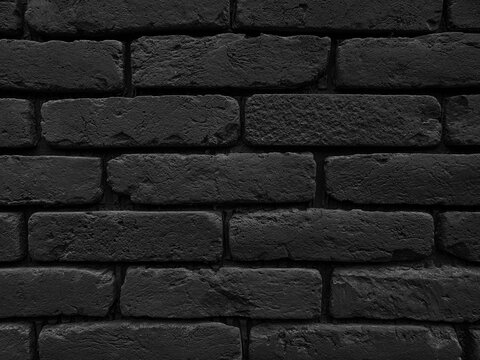Black brick wall grunge texture background. Close up of brick tiles in a row.