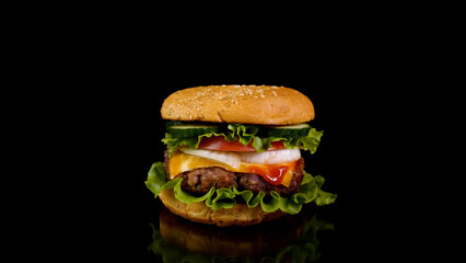 Big appetizing burger on a black background