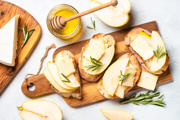 Sweet toast with pear, cheese and honey. Healthy snack or breakfast. Top view.