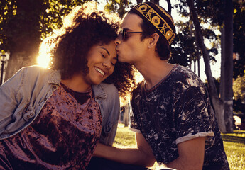 young loving interracial couple kissing outdoors
