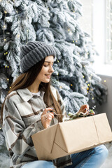 A beautiful girl on a New Year's photo shoot in the studio. The New Year Concept. Long hair style and makeup. Young attractive woman in luxury interior.