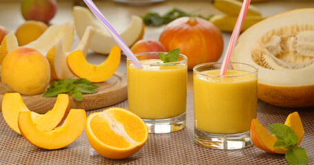 Melon banana Smoothie into a glass on the background of fresh fruits