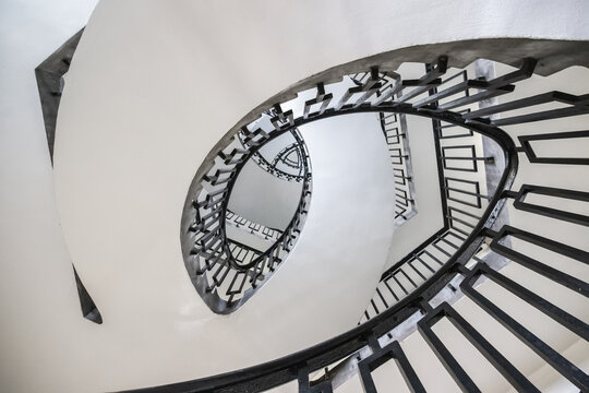 Looking up at a spiral staircase in George Loveless House in London