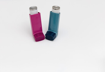 Asthma medications inhalers on a white background.