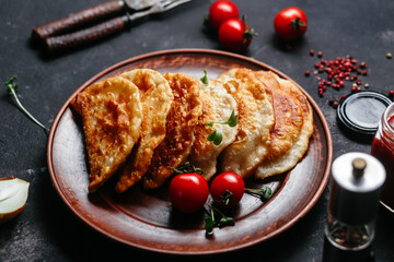 Chebureks with meat on a plate. Fried pies