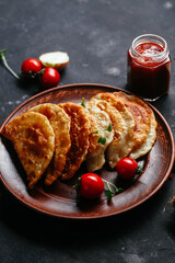 Chebureks with meat on a plate. Fried pies