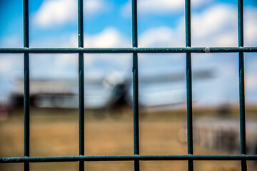 Fence against the background of a standing plane