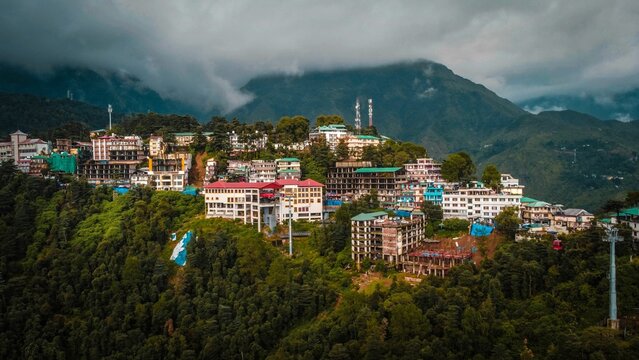 Colorful buildings on the peak of mountains over the dense rainy clouds, Himachal Pradesh India