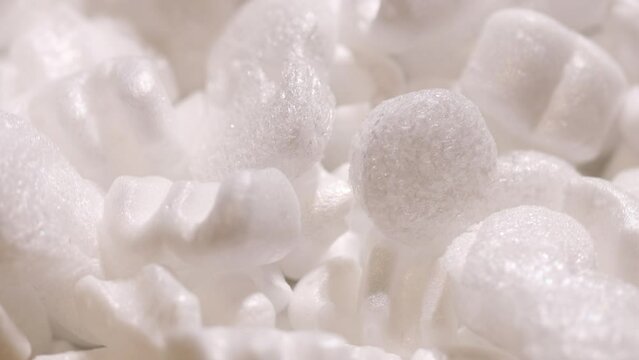 pieces of white foam rotate in a circle. packaging material
