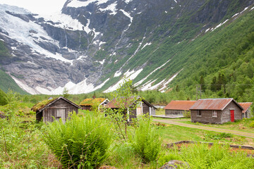 Fototapeta na wymiar Fjaerland, Norway - June 10 2022: view at Jostedal Glacier with traditional Norway houses