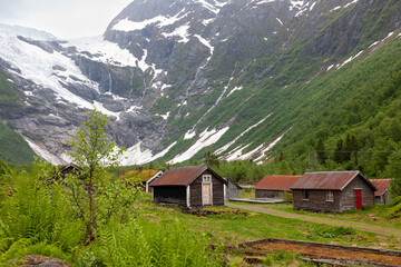Obraz premium Fjaerland, Norway - June 10 2022: view at Jostedal Glacier with traditional Norway houses