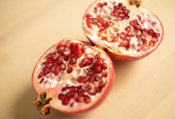 large fruit, fruit, pomegranate, cut into two halves with a knife, on a wooden board. Weight loss,...