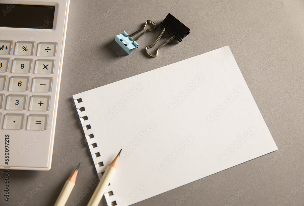 Aufkleber empty paper with pencils and calculator on the table
