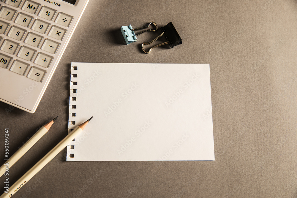 Poster empty paper with pencils and calculator on the table