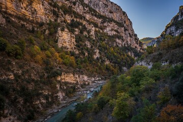 Low angle of river Verdon and a rugged cliff in the Blanc-Martel hiking trail in France