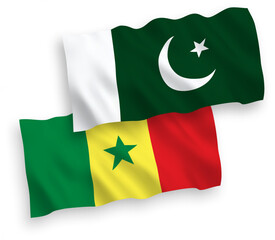 National vector fabric wave flags of Republic of Senegal and Pakistan isolated on white background. 1 to 2 proportion.