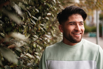 portrait of young colombian man in sportswear in nature
