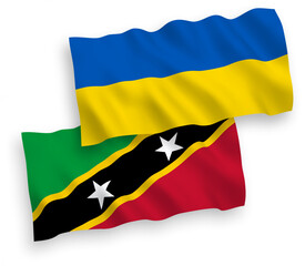 National vector fabric wave flags of Federation of Saint Christopher and Nevis and Ukraine isolated on white background. 1 to 2 proportion.
