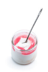 Fresh natural homemade organic yogurt with berry jam and chia seed in a glass jar isolated on white