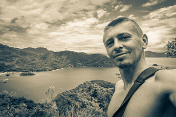 Fototapeta premium Tourist traveler with Ilha Grande Abraao beach panorama Brazil.